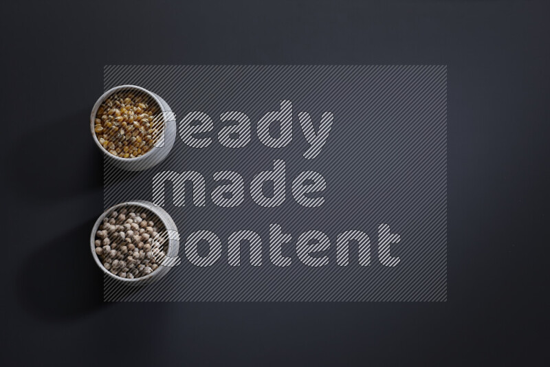 Legumes in pottery bowls on grey background