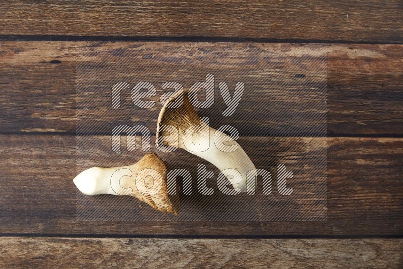 Fresh King oysters mushrooms topview on a wooden background