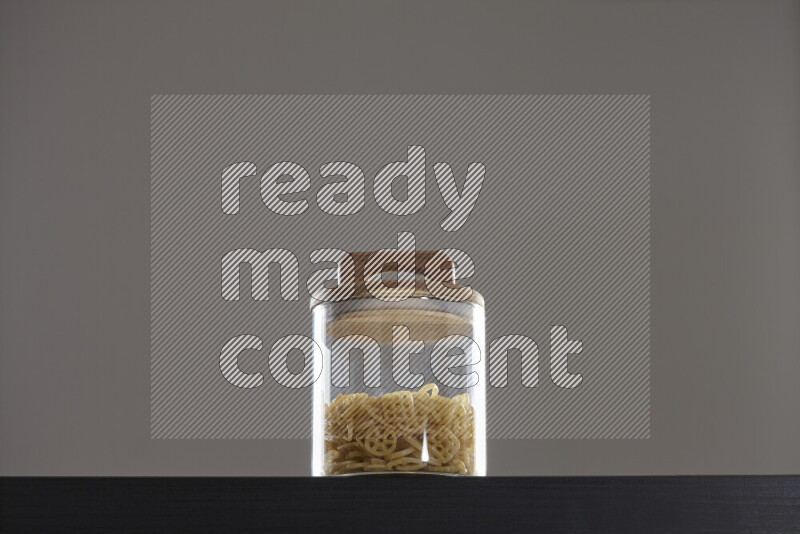 Snacks in a glass jar on black background