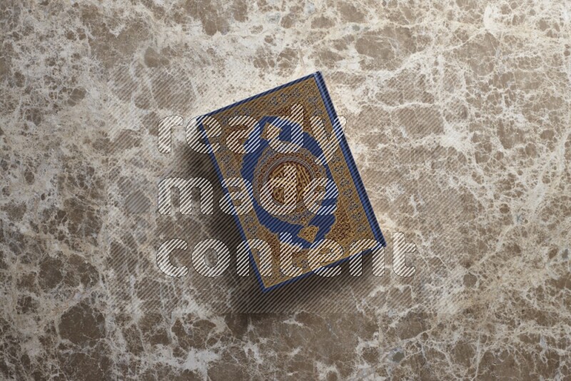 The holy Quran on beige marble background