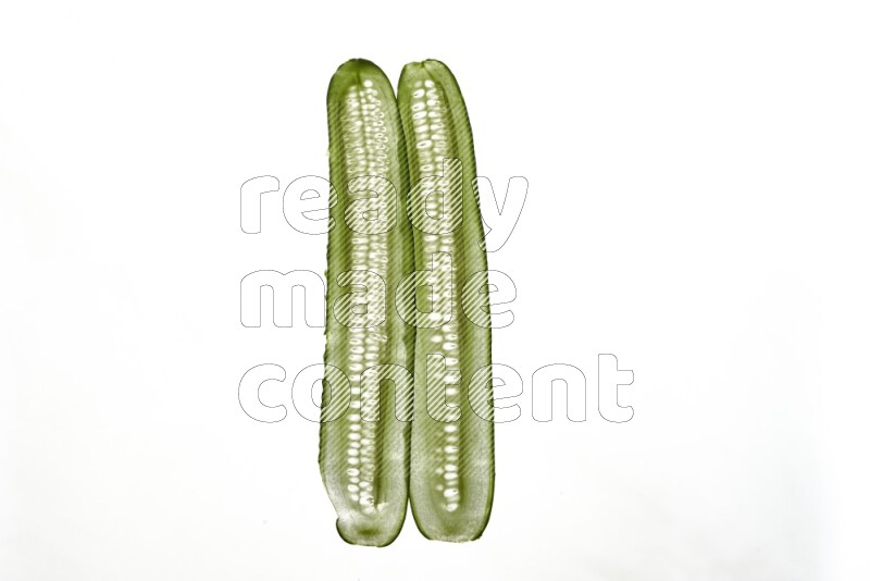 Cucumber slices on illuminated white background