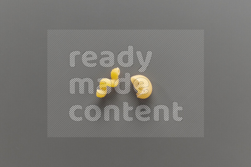 Twist pasta with other types of pasta on grey background