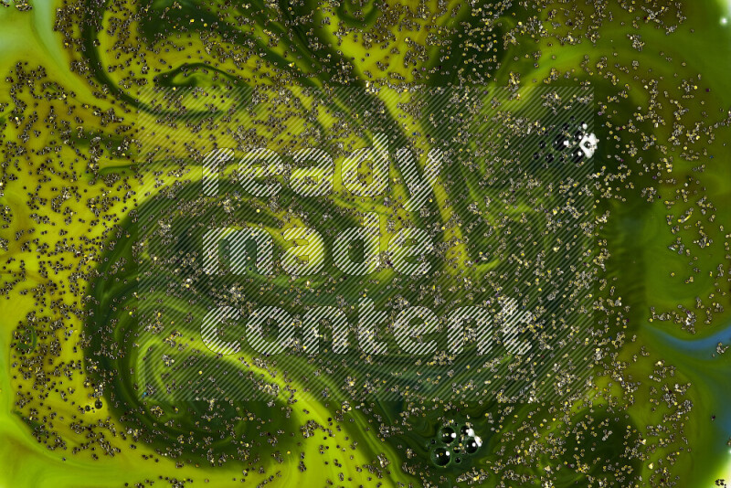 A close-up of sparkling gold glitter scattered on swirling green background