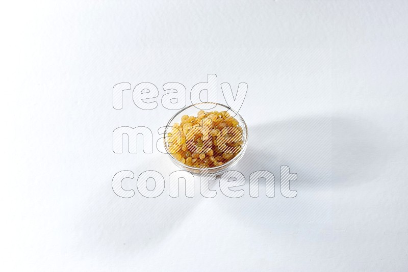 A glass bowl full of raisins on a white background in different angles