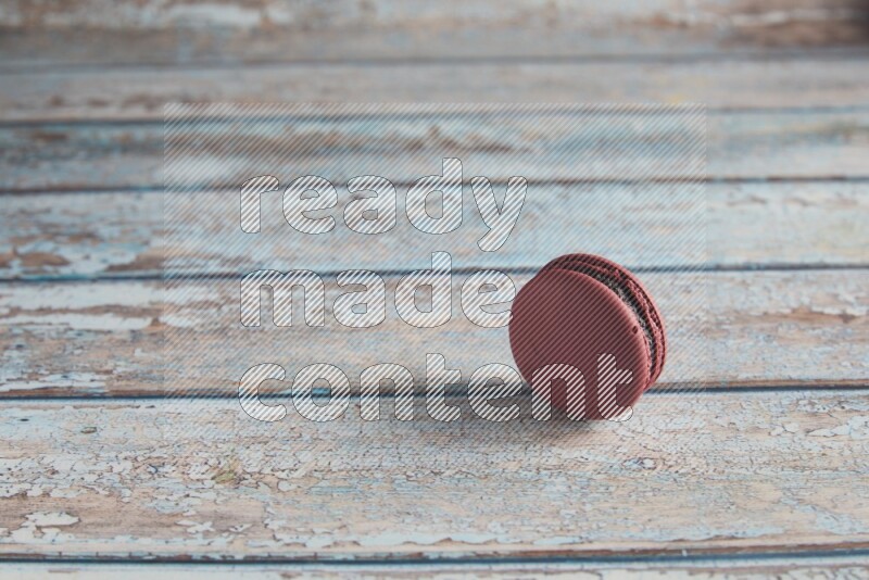 45º Shot of Red Cherry macaron on light blue wooden background
