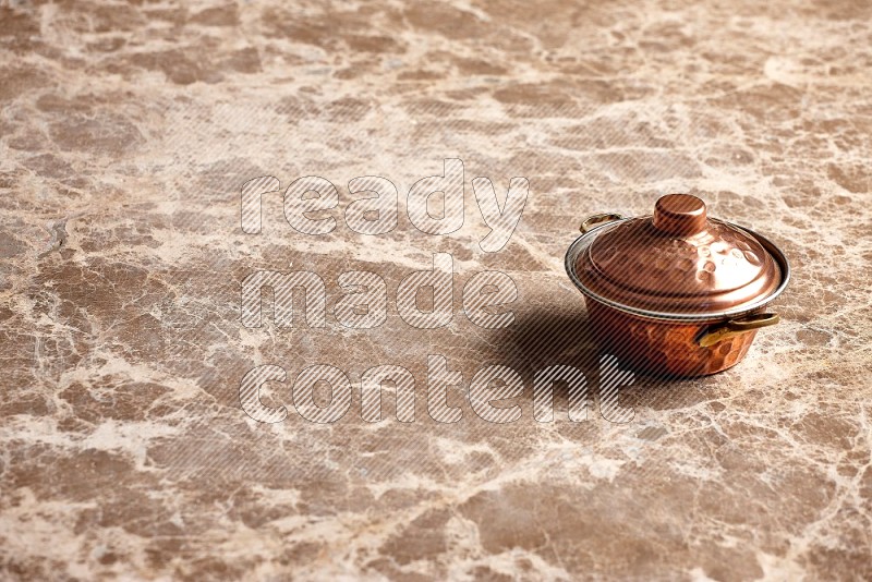 Small Copper Pot on Beige Marble Flooring, 45 degrees