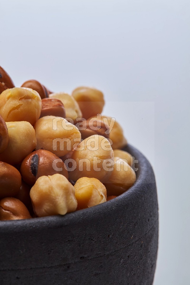 Close up shot of cooked fava beans (foul) & chickpeas on white background