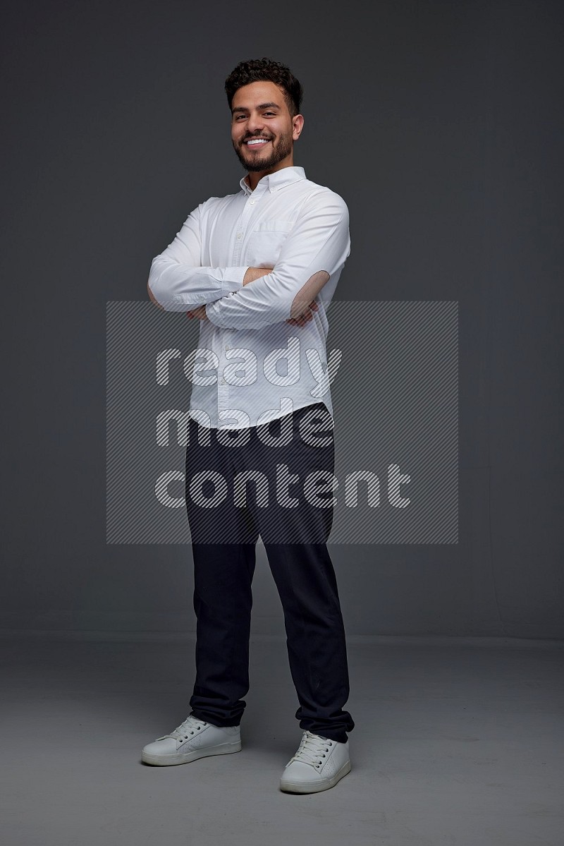 A man wearing smart casual making multi stand poses  eye level on a gray background