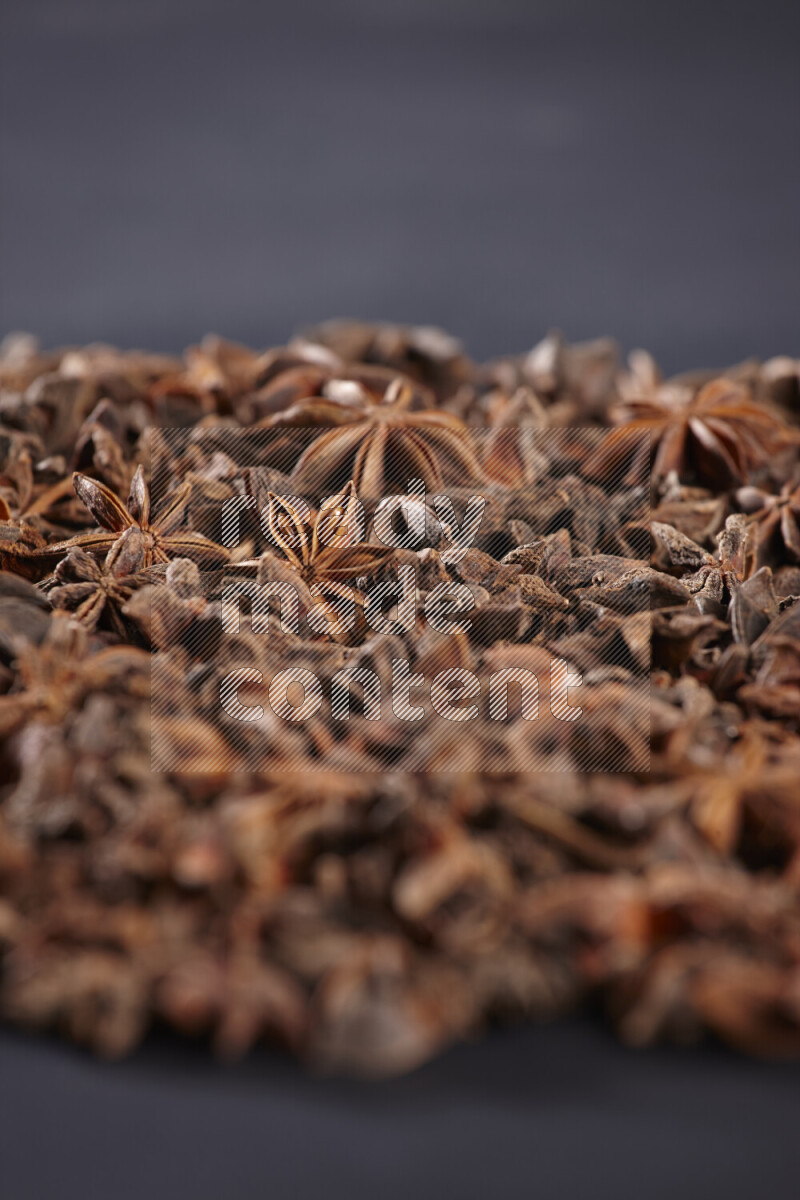 Star Anise fill the frame on black flooring