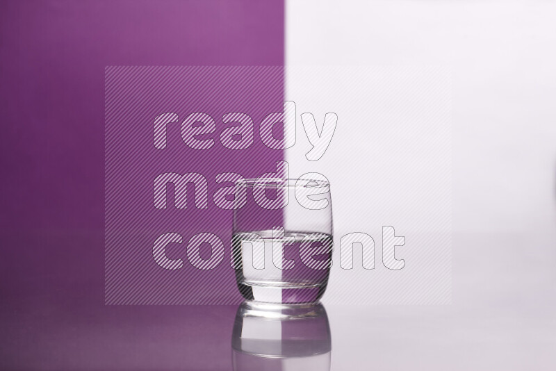 The image features a clear glassware filled with water, set against white and purple background