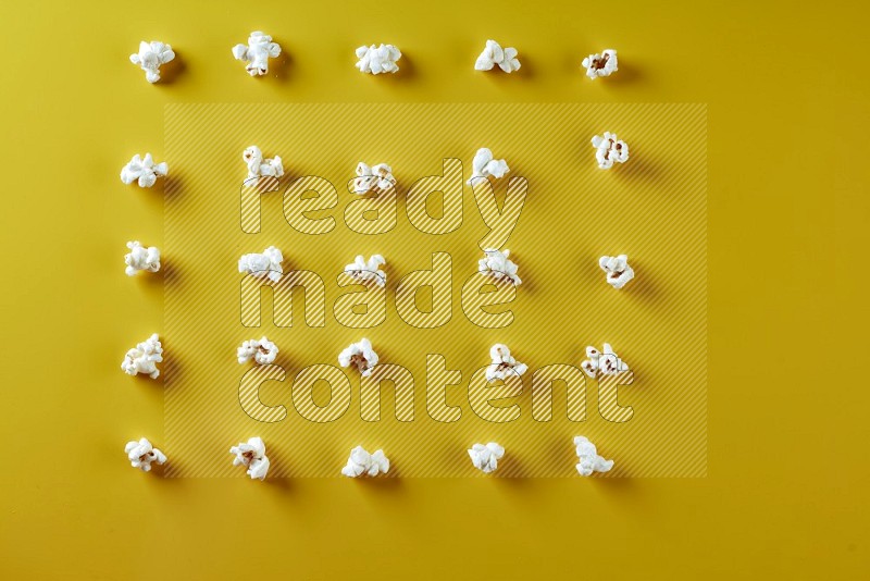 Popcorn flakes on a yellow background in different angles