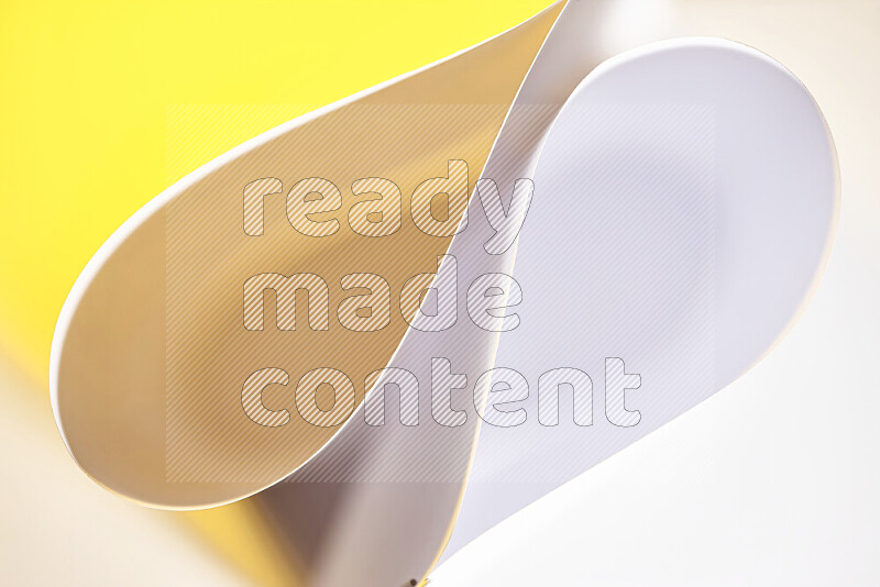 An abstract art of paper folded into smooth curves in white and yellow gradients