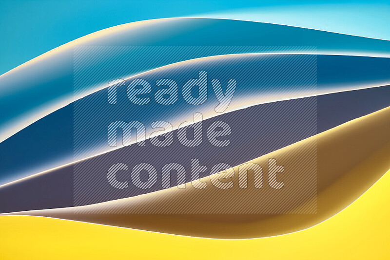 This image showcases an abstract paper art composition with paper curves in blue and yellow gradients created by colored light