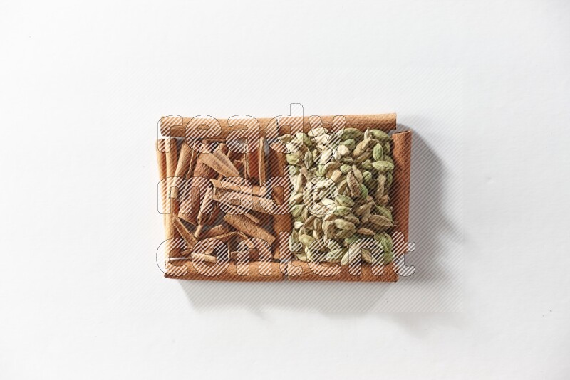 2 squares of cinnamon sticks full of cinnamon and cardamom on white flooring