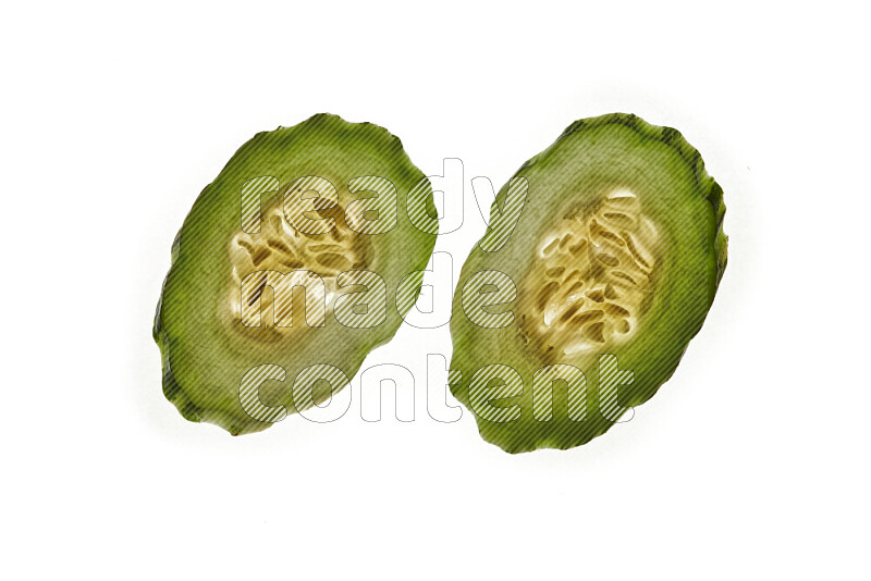 Cucumber slices on illuminated white background