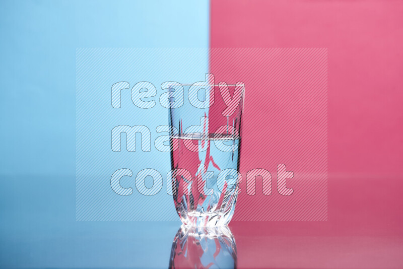 The image features a clear glassware filled with water, set against light blue and pink background