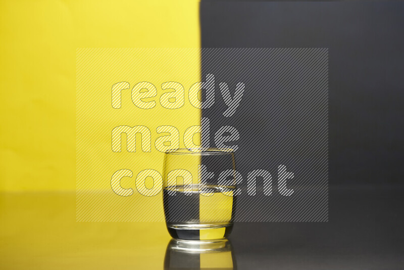 The image features a clear glassware filled with water, set against yellow and black background