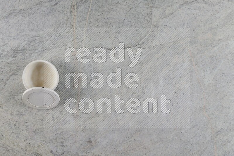 A multicolored pottery Cup on grey marble background