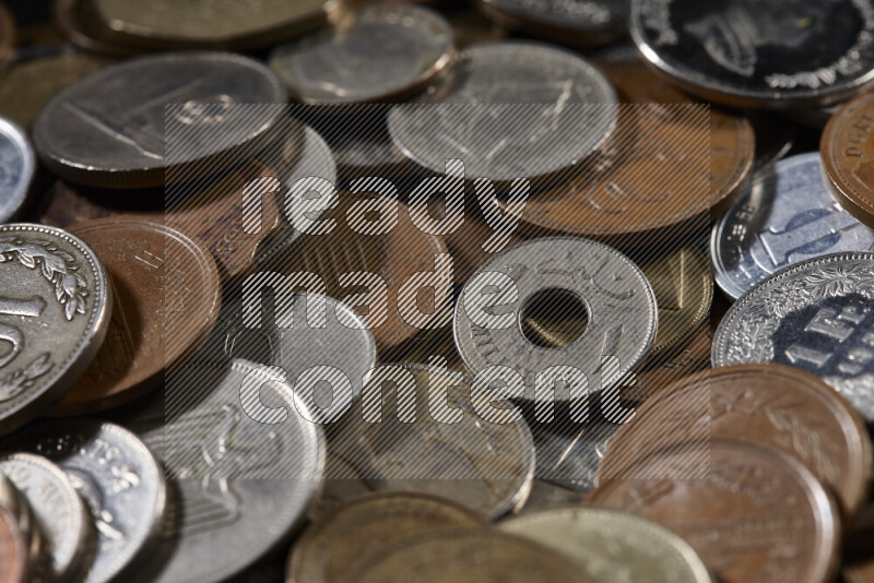 A close-ups of random old coins on black background