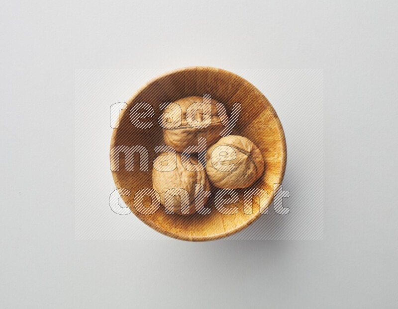 Top-view shot of walnut in a container on white background