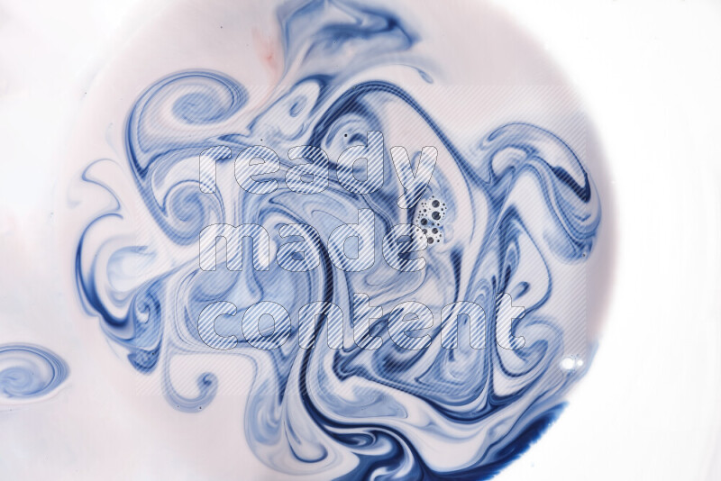 A close-up of abstract swirling patterns in blue, red and white