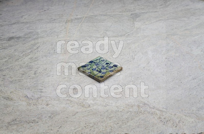 Top view shot of a pottery coaster\ tile on beige marble flooring