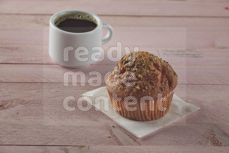 Pistachio cupcake on a wooden pink background