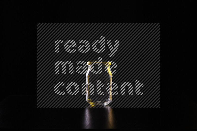 Glassware with rim light in yellow and white against black background