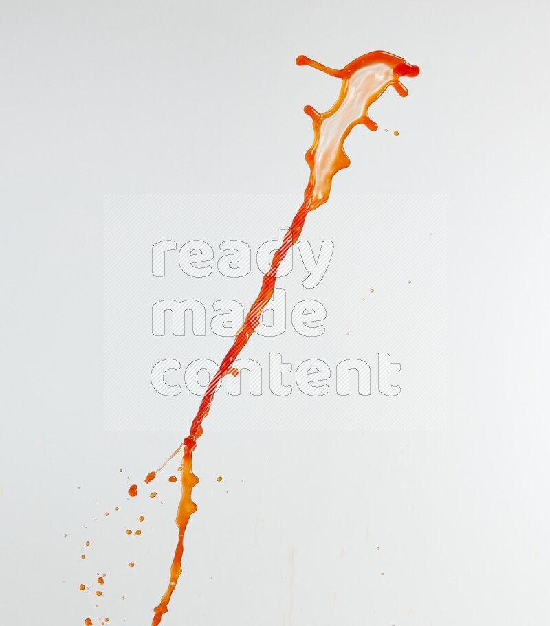 Orange liquid splash and drops on white background