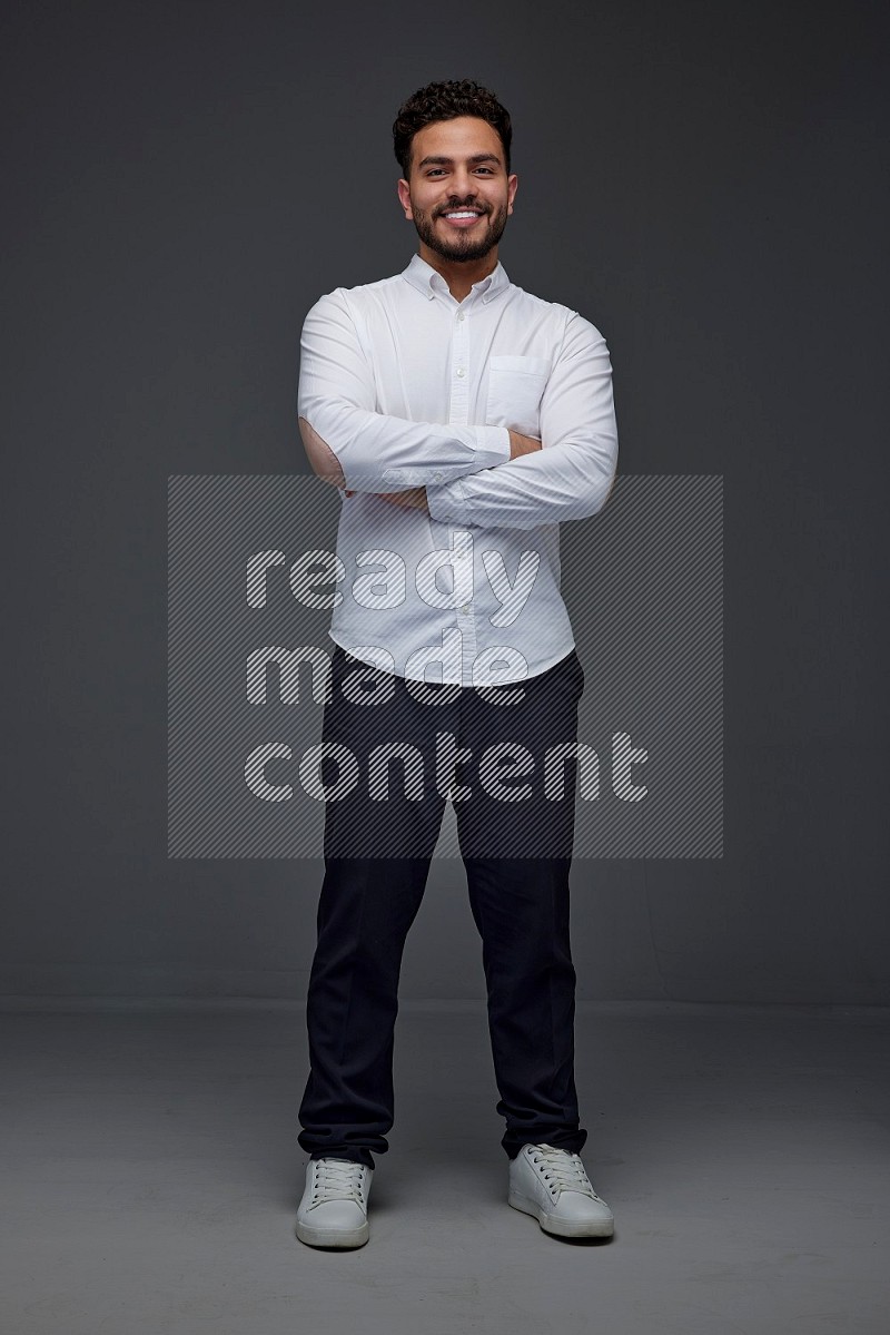 A man wearing smart casual making multi stand poses  eye level on a gray background