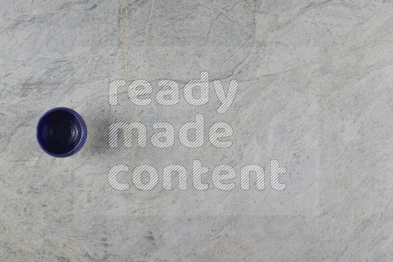 A multicolored pottery Cup on grey marble background