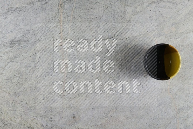 Top View Shot Of A Multicolored Pottery Bowl On Grey Marble Flooring