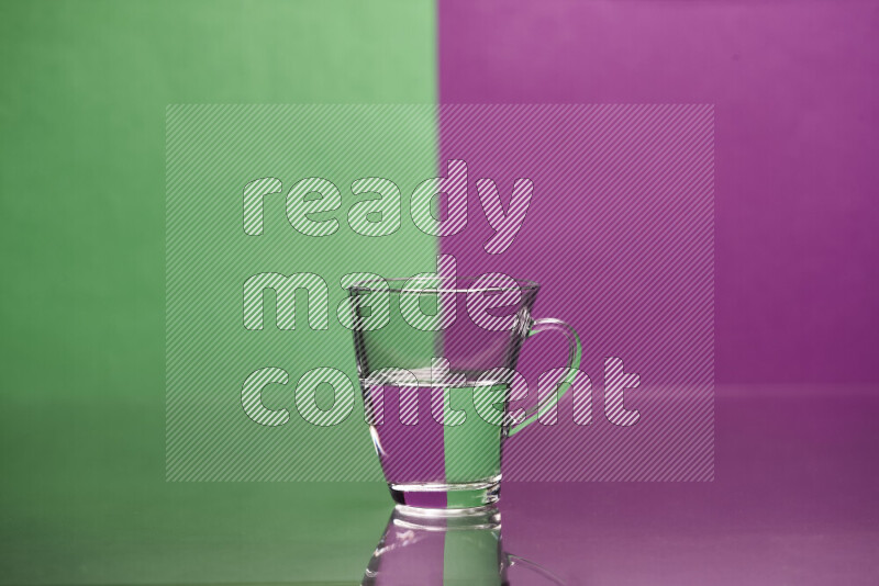 The image features a clear glassware filled with water, set against green and purple background