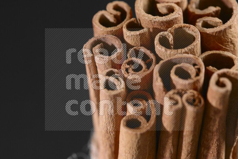 Cinnamon sticks on black background