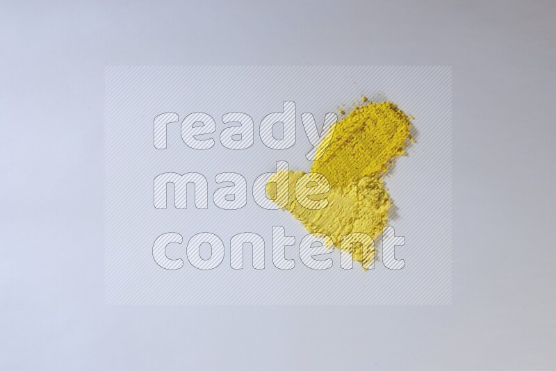 Yellow powder strokes on white background