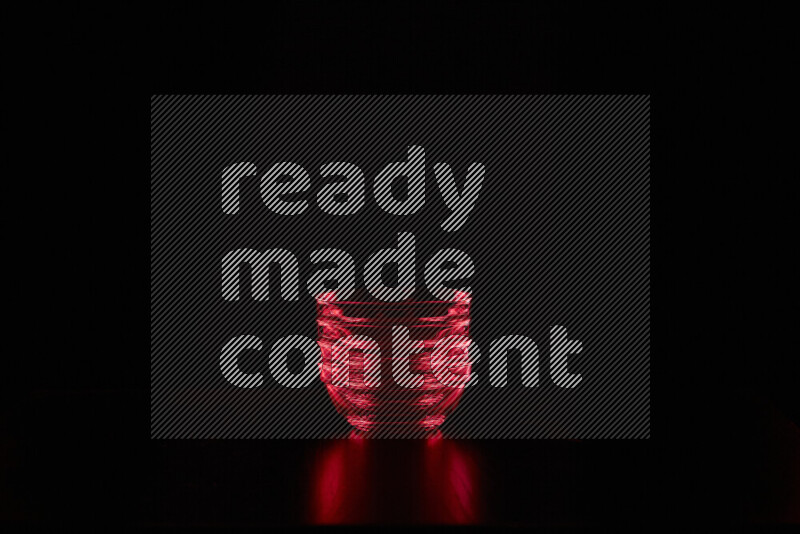 Glassware with rim light in red against black background