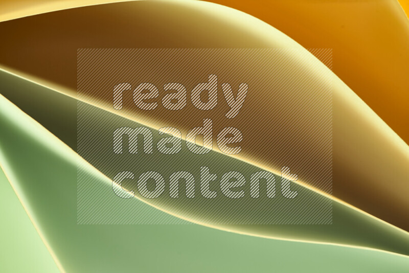This image showcases an abstract paper art composition with paper curves in green and orange gradients created by colored light