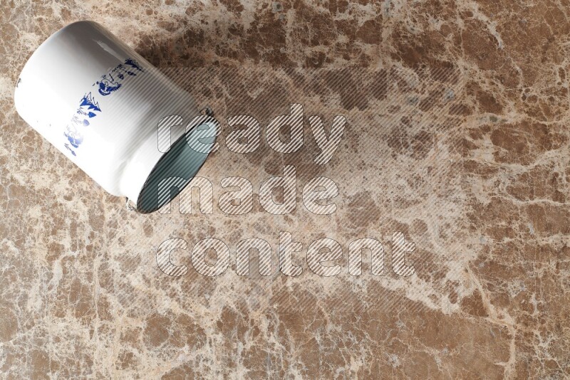 A vintage milk can on beige marble background