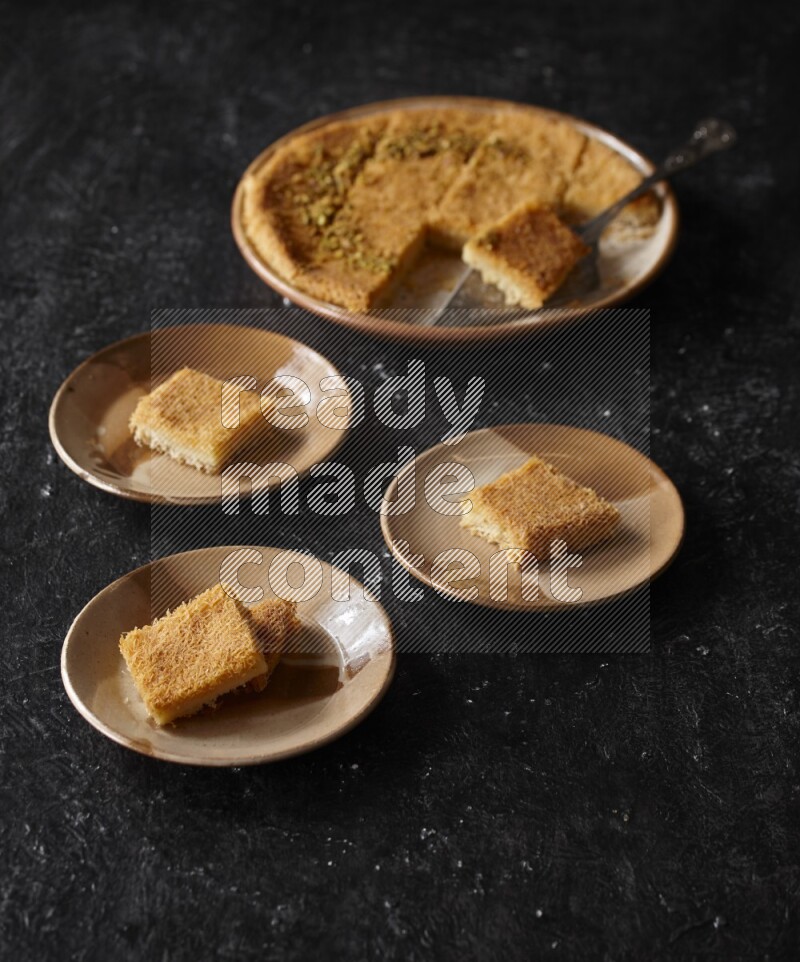 Konafa in different plates in a dark setup