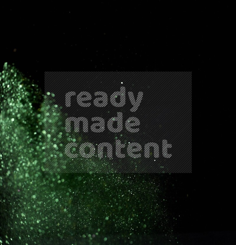 Green glitter powder isolated on black background