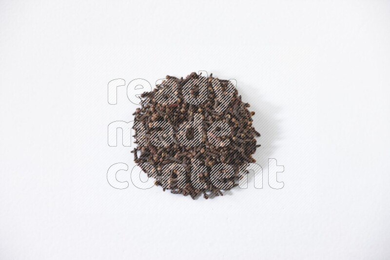 Cloves in a circle shape on a white flooring