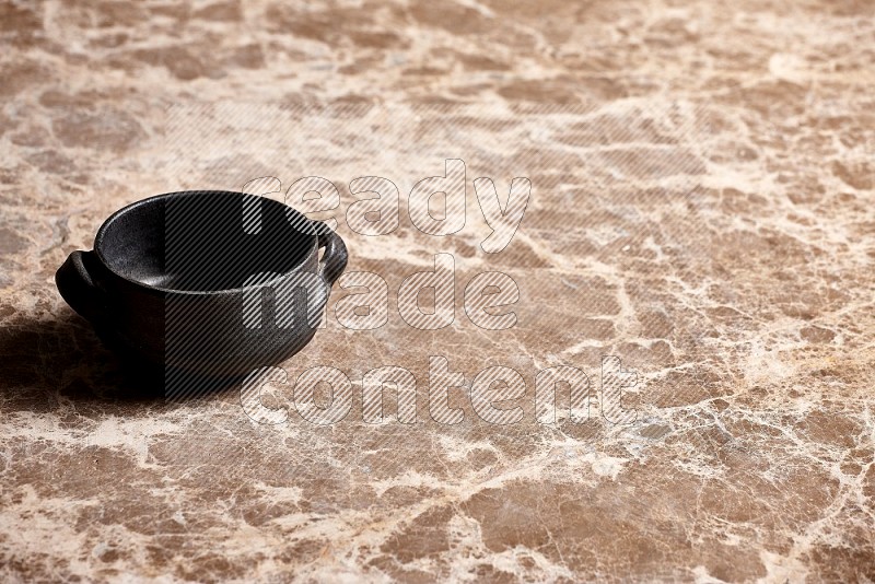 Black Pottery Bowl on Beige Marble Flooring, 45 degrees