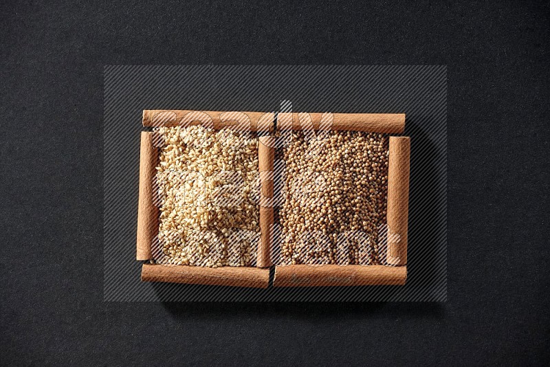 2 squares of cinnamon sticks full of mustard seeds and sesame on black flooring