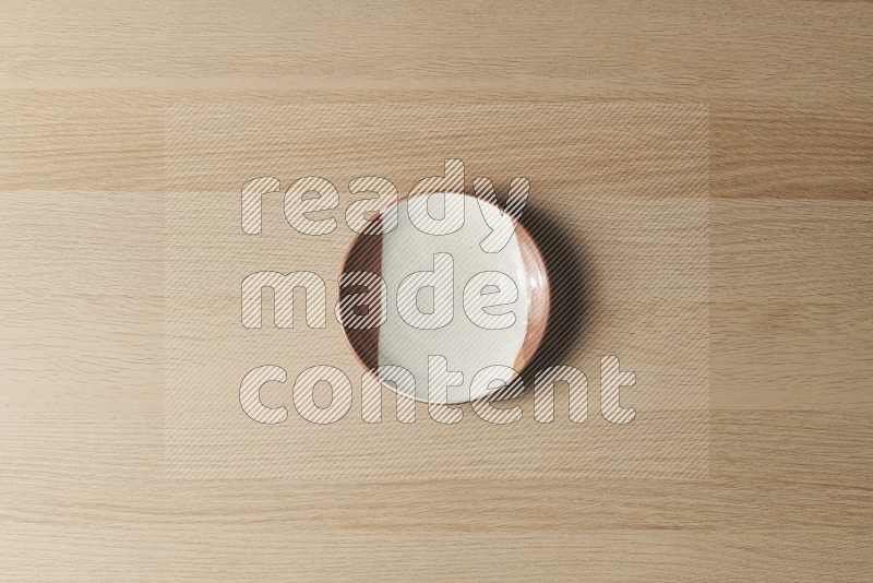 Top View Shot Of A Multicolored Pottery Plate on Oak Wooden Flooring