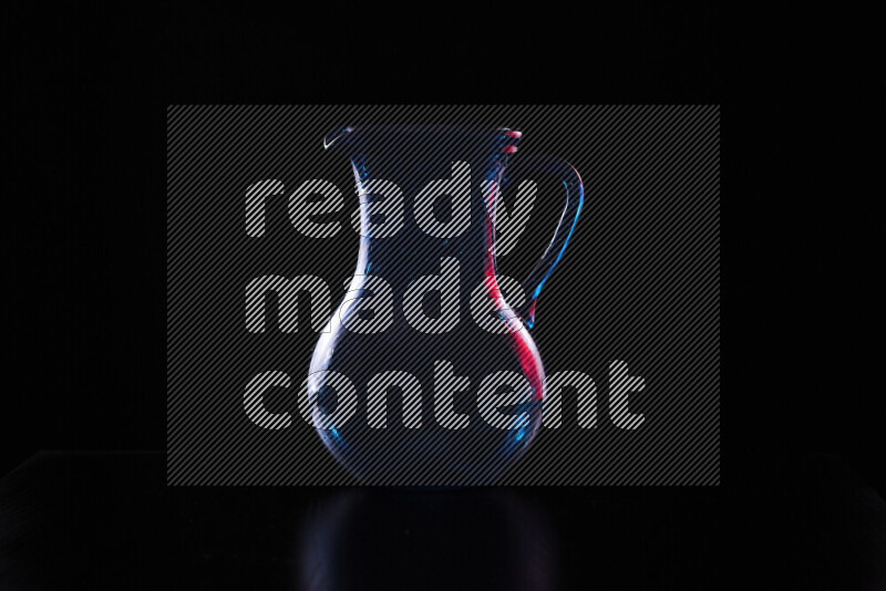 Glassware with rim light in red and white against black background