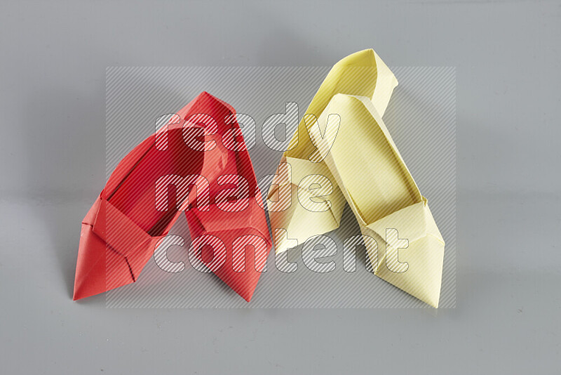 Origami shoes on grey background