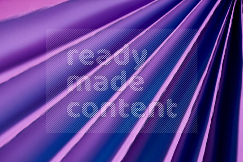 An image presenting an abstract paper pattern of lines in purple tones