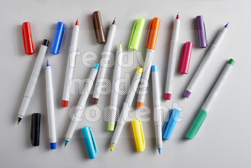 An arrangement of coloring pens in different colors on grey background
