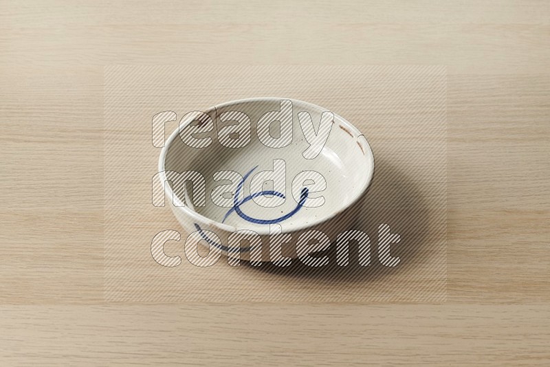 Multicolored Pottery Bowl on Oak Wooden Flooring, 45 degrees