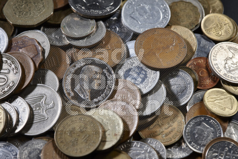 A close-ups of random old coins on black background